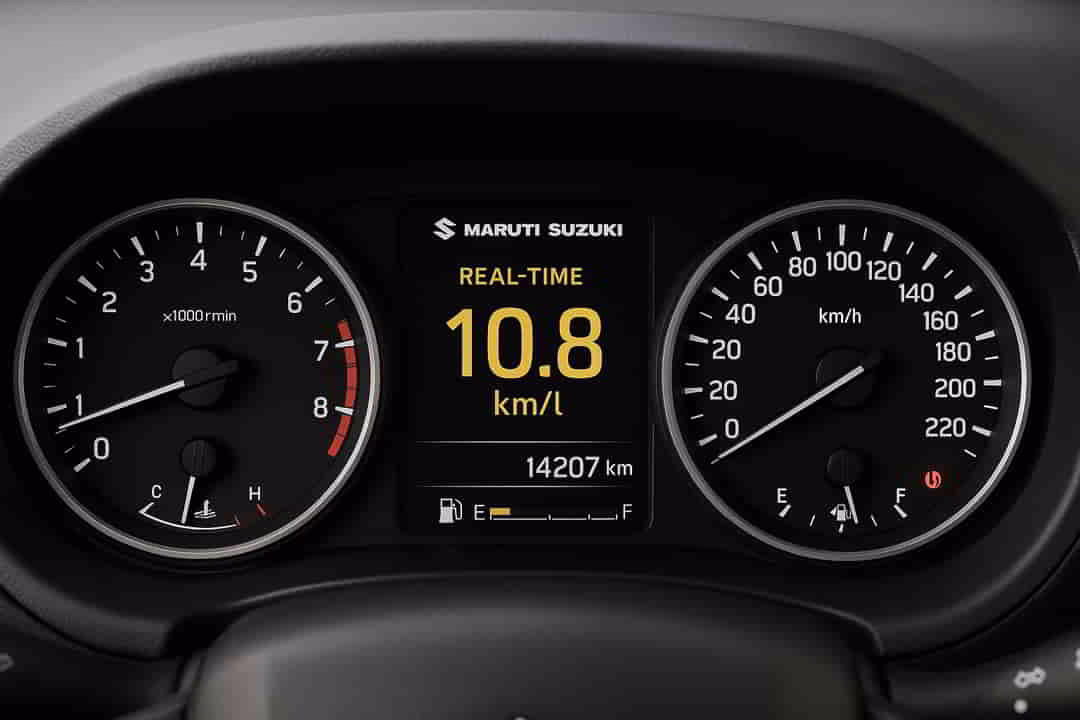 Car dashboard showing fuel efficiency drop on steep climb.